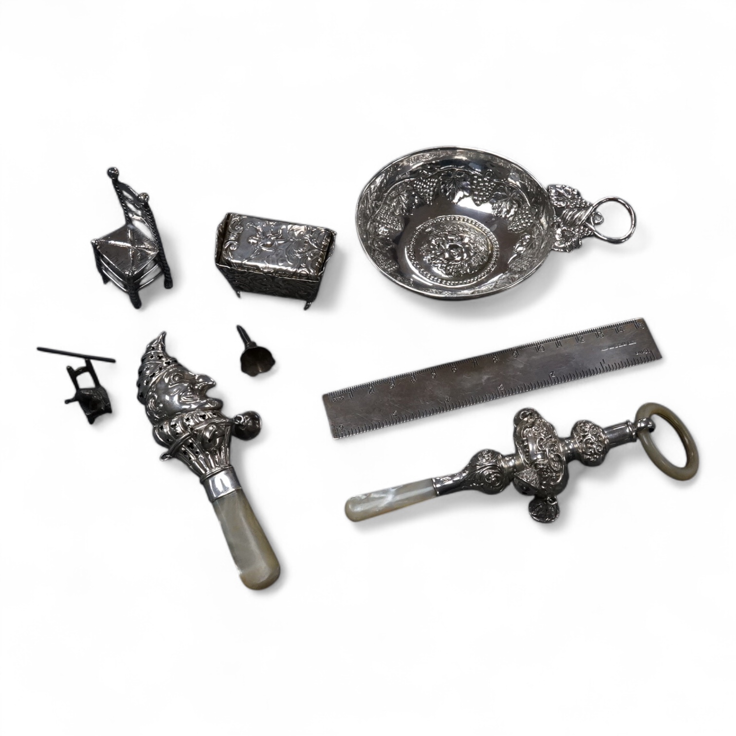 A small group of collectable silver including a Dutch miniature silver cradle box, import marks for London, 1898, 53mm, two other white metal miniature items including a chair, a continental 930 white metal taste vin, a